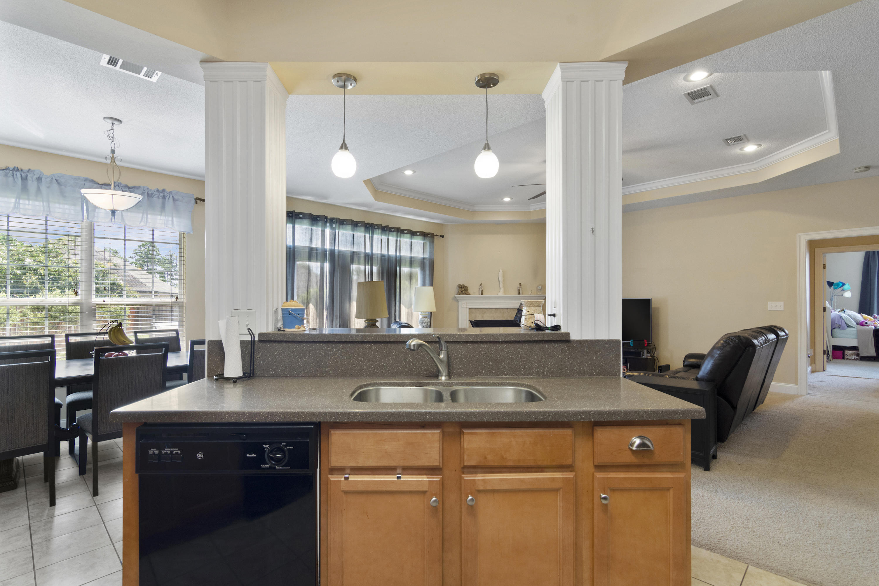 145 Alicia Drive Crestview, FL 32536 - Photo 10 of 32 a kitchen with granite countertop a sink and a refrigerator