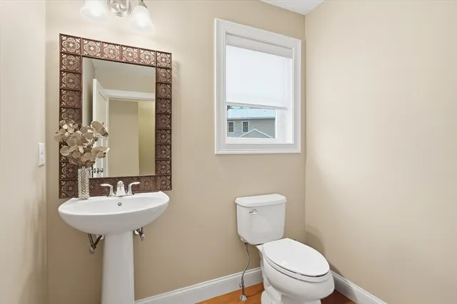 a bedroom with a bed chandelier and a window