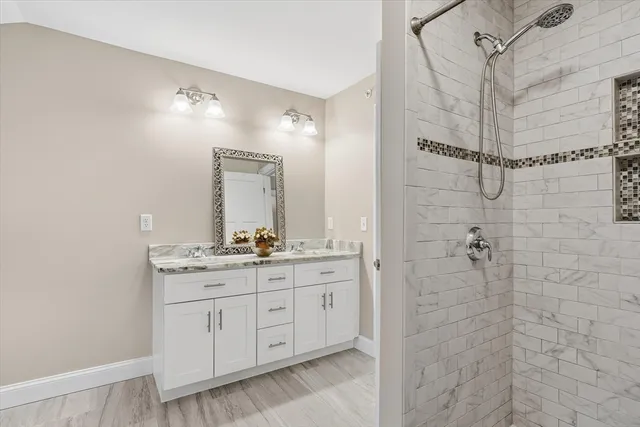 a bathroom with a granite countertop sink mirror and toilet