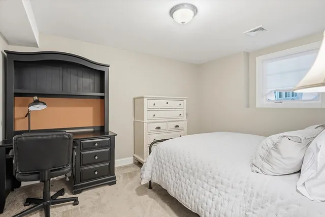 a bedroom with a bed and a table in it