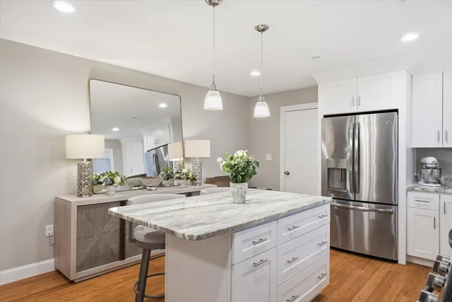 a kitchen with kitchen island a sink appliances and cabinets