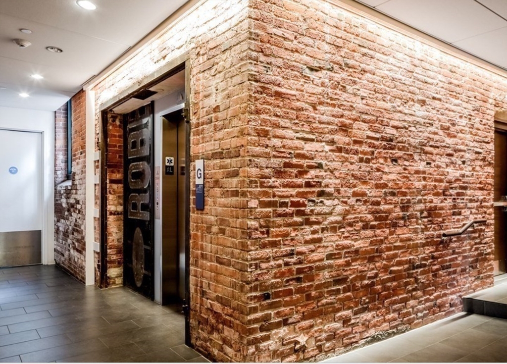 63 Melcher Street, Unit 404 Boston, MA 02210 - Photo 12 of 12 a view of walk in closet with clothes