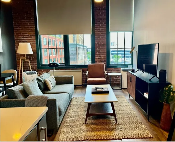 a living room with furniture rug and window