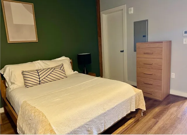 a bedroom with a bed and a window