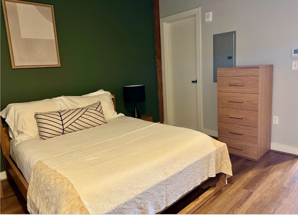 63 Melcher Street, Unit 404 Boston, MA 02210 - Photo 8 of 12 a bedroom with a bed and a window