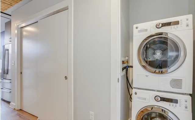 a close view of a utility room with dryer and washer