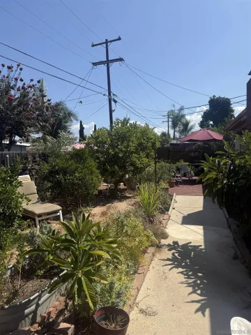 a backyard of a house with a yard and outdoor seating