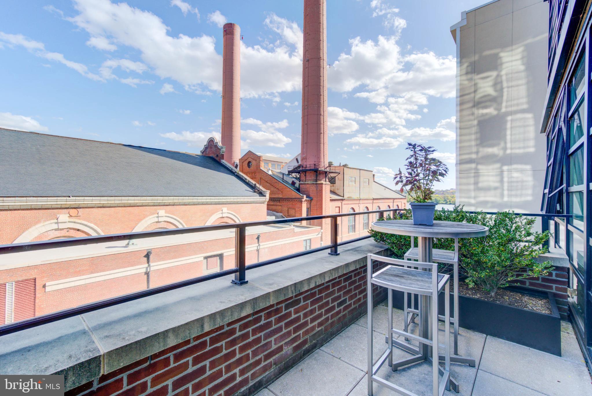 1300 4th Street Southeast, Unit 414 Washington, DC 20003 - Photo 15 of 31 a roof deck with table and chairs and wooden floor