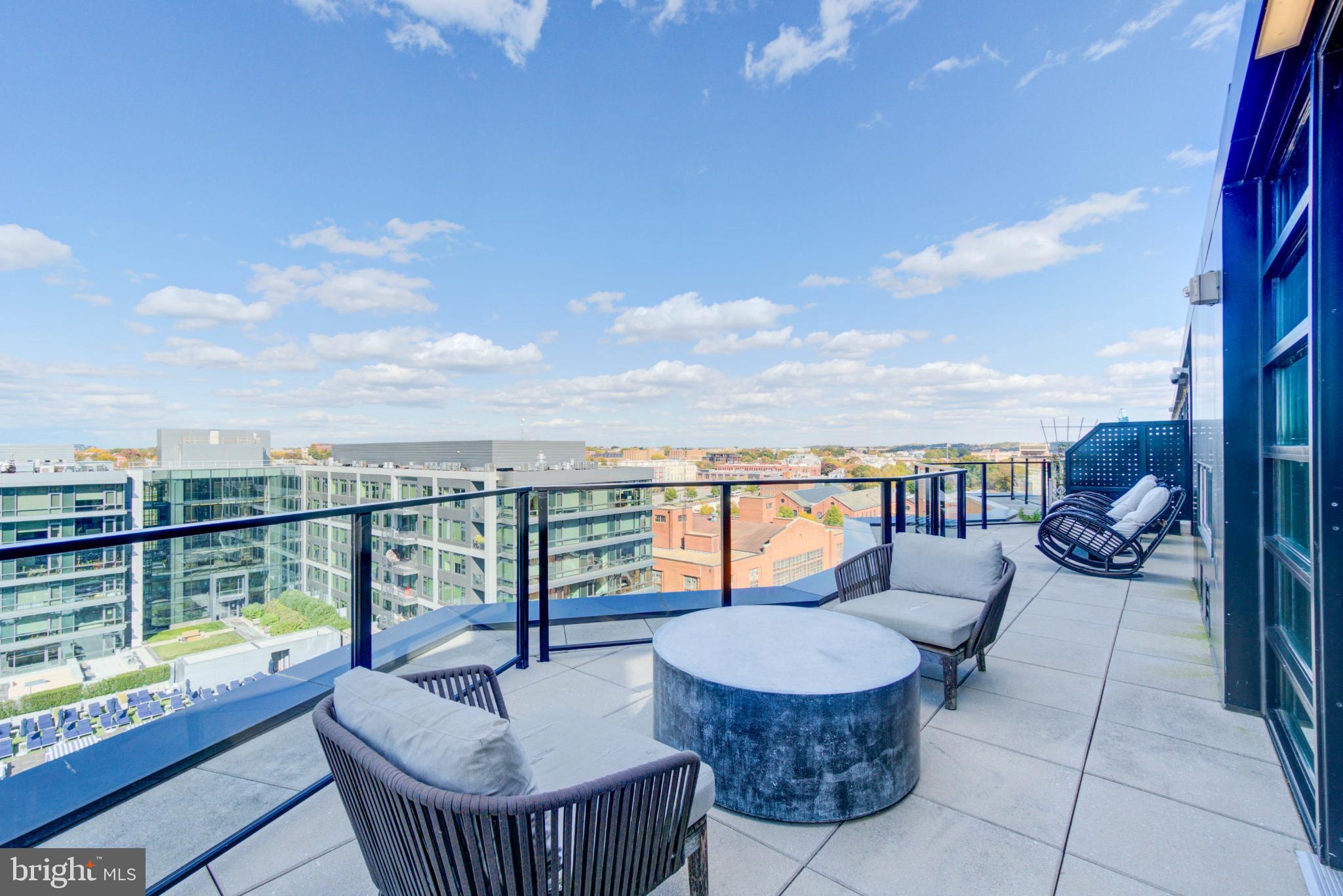 1300 4th Street Southeast, Unit 414 Washington, DC 20003 - Photo 24 of 31 a view of a roof deck with couches and sky view