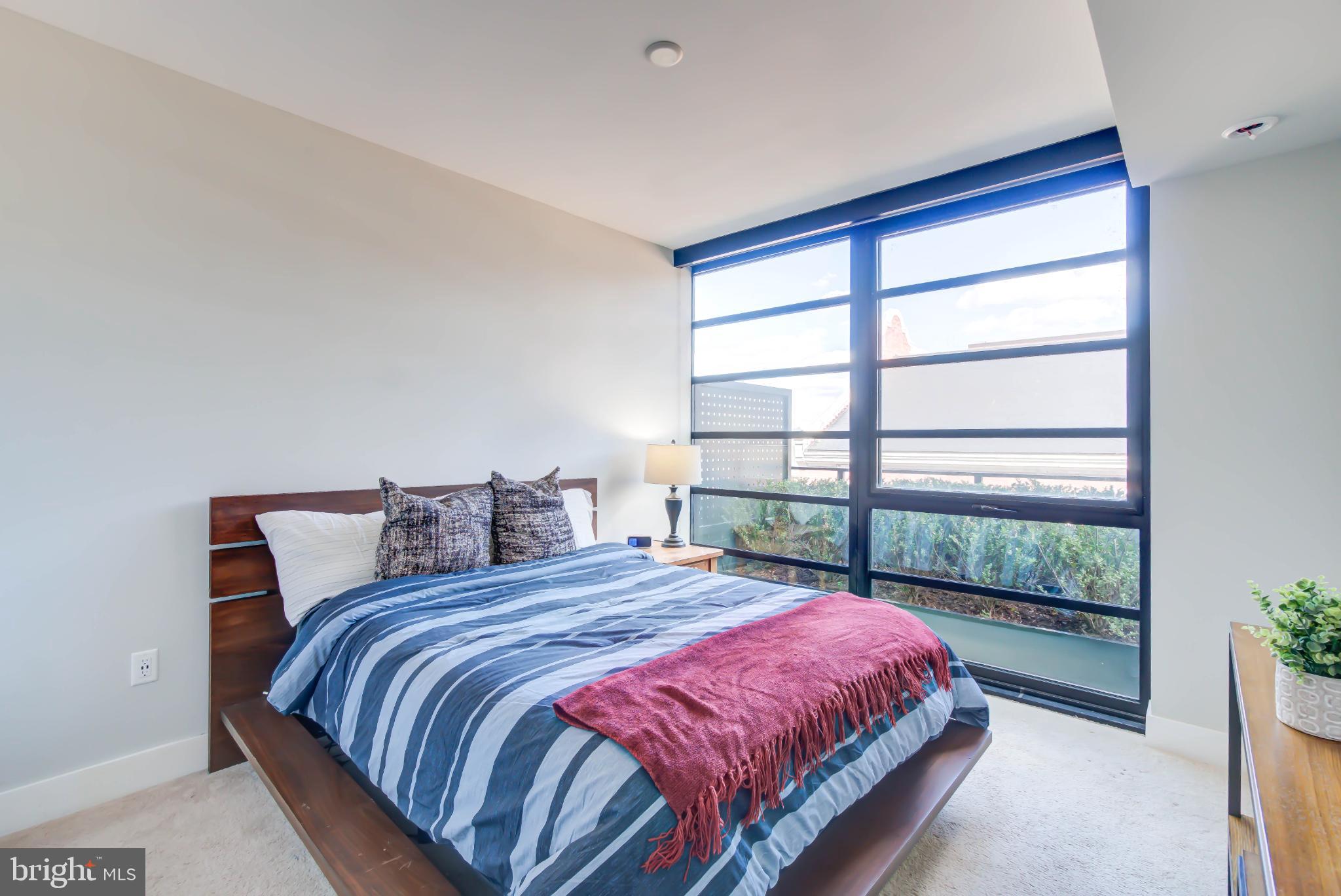 1300 4th Street Southeast, Unit 414 Washington, DC 20003 - Photo 9 of 31 a bed sitting in a bedroom next to a window