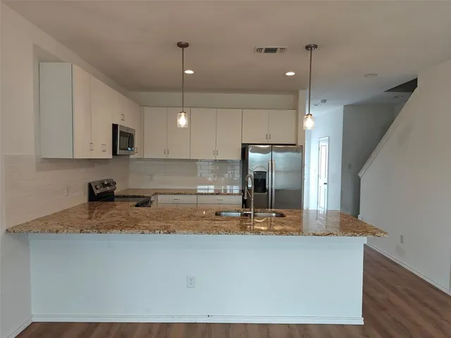 a kitchen with counter top space cabinets and stainless steel appliances