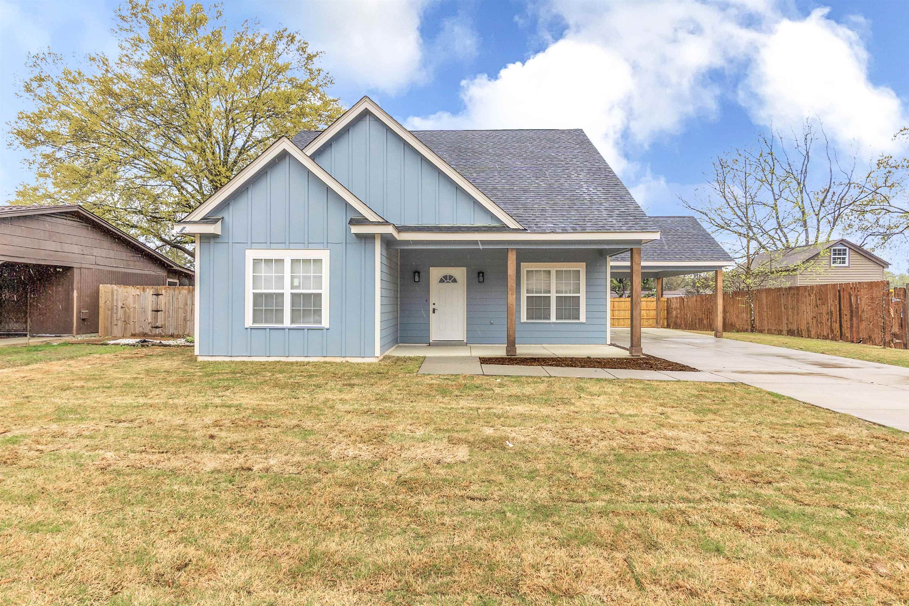 4397 Crescent Park Drive Memphis, TN 38141 - Photo 1 of 40 View of front of property with driveway, a front yard, fence, board and batten siding, and a carport