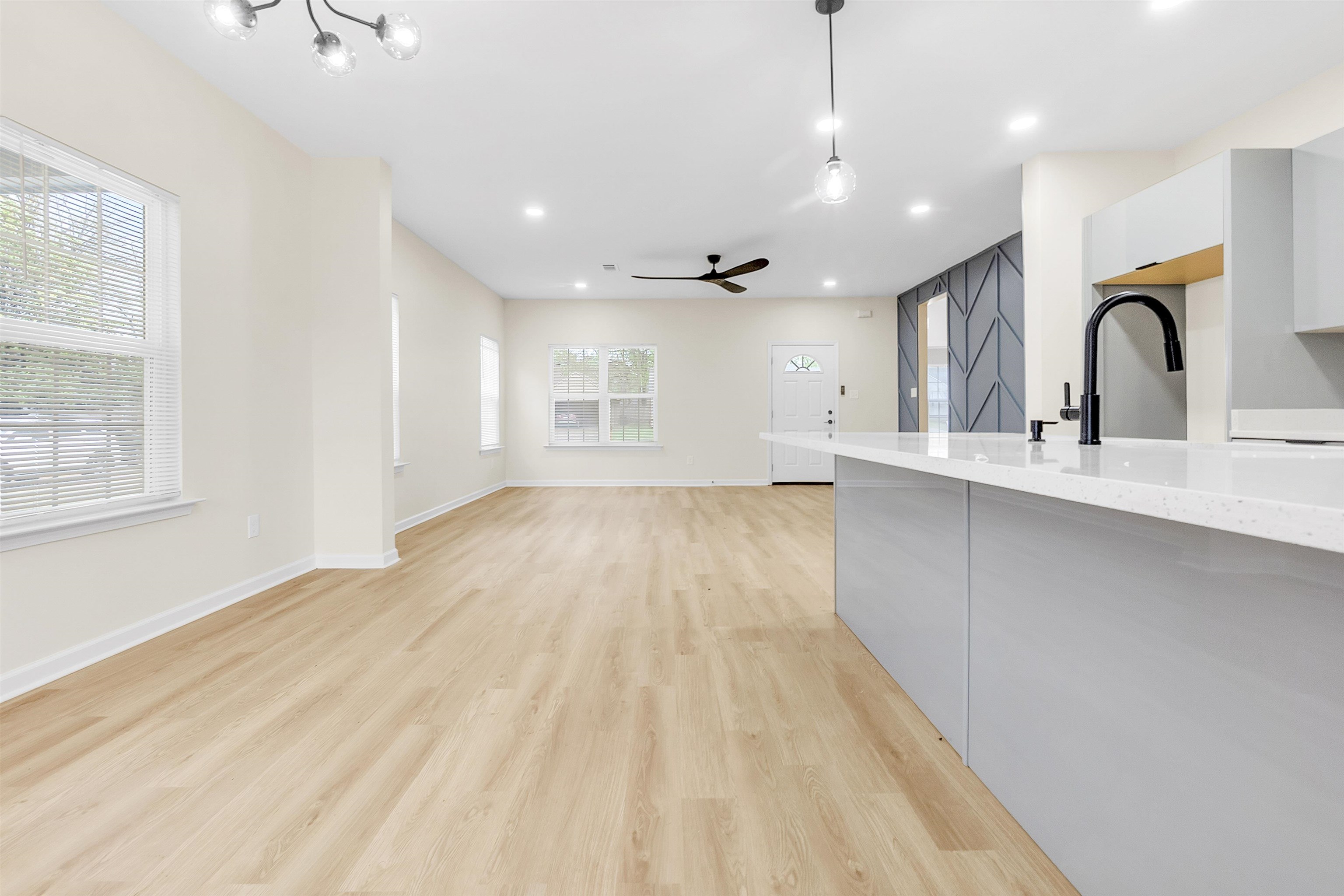 4397 Crescent Park Drive Memphis, TN 38141 - Photo 15 of 40 Kitchen with ceiling fan with notable chandelier, baseboards, pendant lighting, light wood finished floors, and modern cabinets