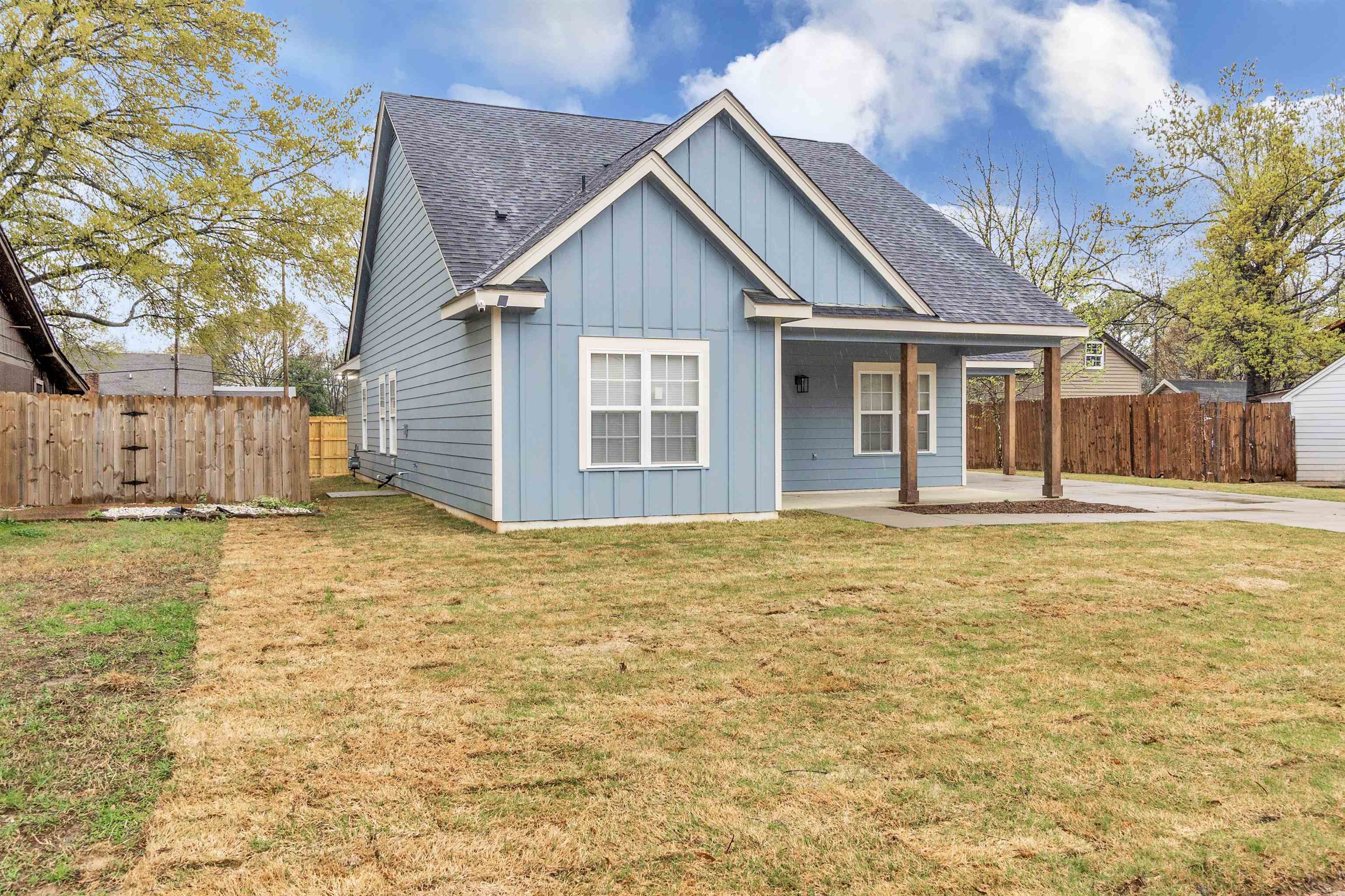 4397 Crescent Park Drive Memphis, TN 38141 - Photo 2 of 40 View of front of house featuring a carport, fence, board and batten siding, and roof with shingles