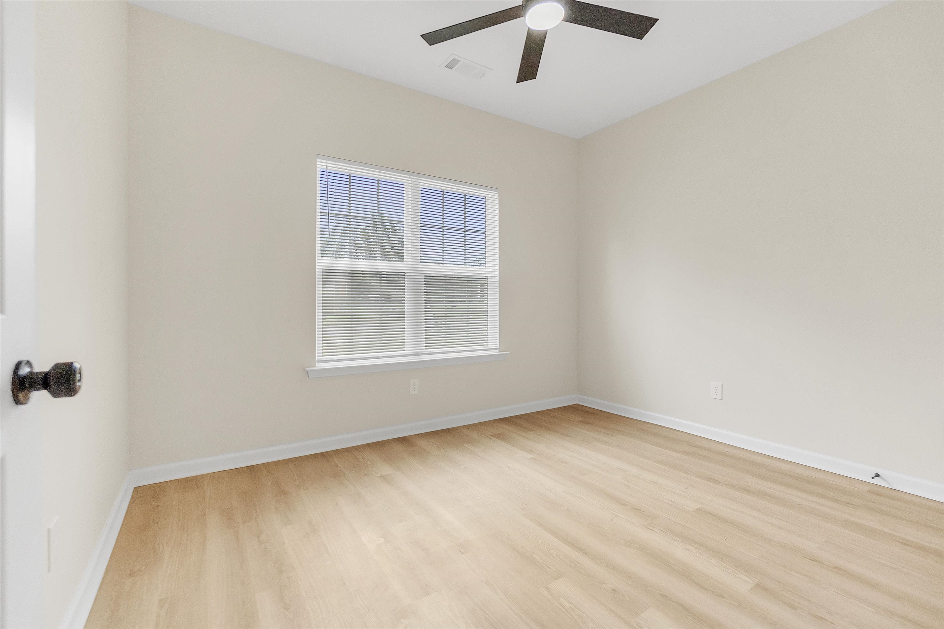 4397 Crescent Park Drive Memphis, TN 38141 - Photo 24 of 40 Unfurnished room featuring baseboards, light wood-style flooring, ceiling fan, and visible vents