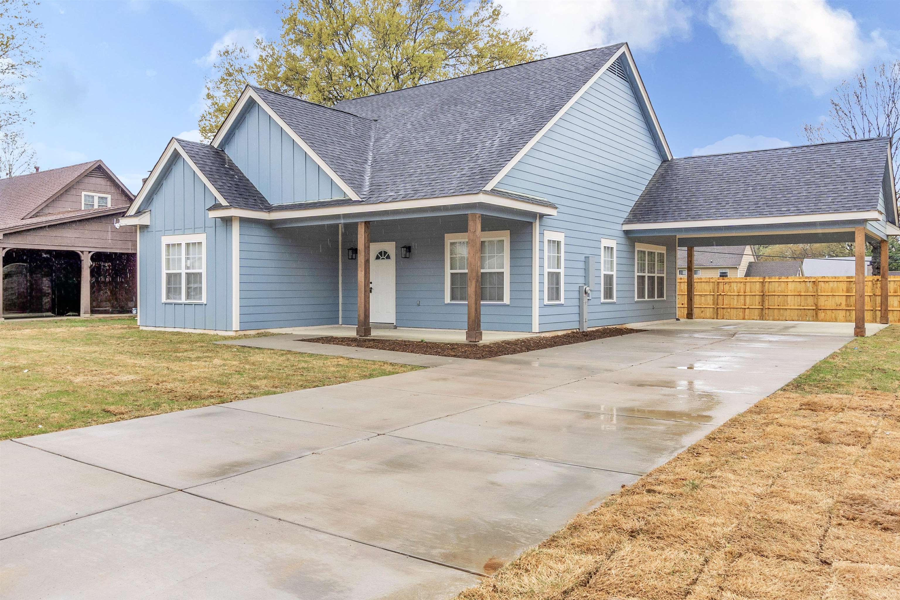 4397 Crescent Park Drive Memphis, TN 38141 - Photo 3 of 40 View of front of house with board and batten siding, a front yard, a shingled roof, and fence