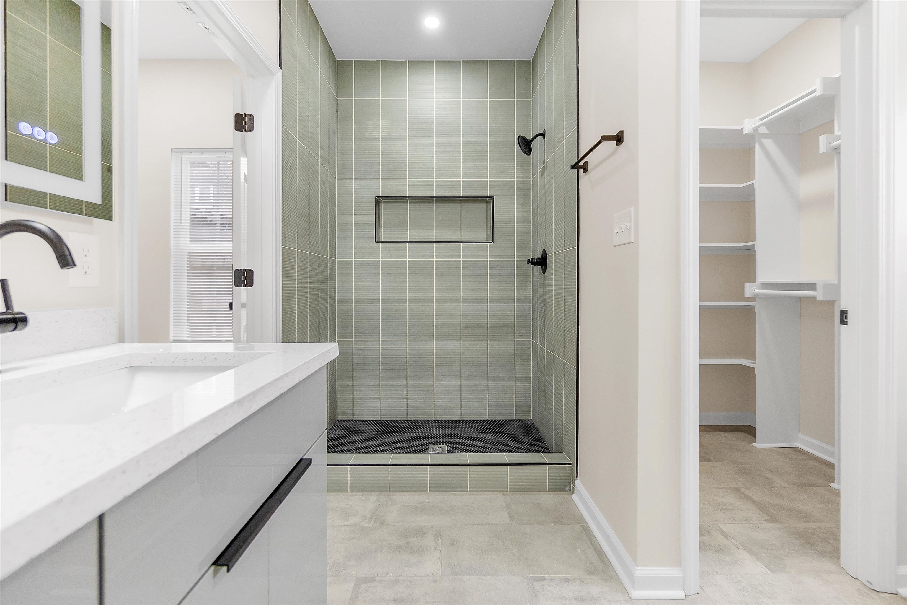 4397 Crescent Park Drive Memphis, TN 38141 - Photo 32 of 40 Bathroom with vanity, baseboards, a walk in closet, and tiled shower