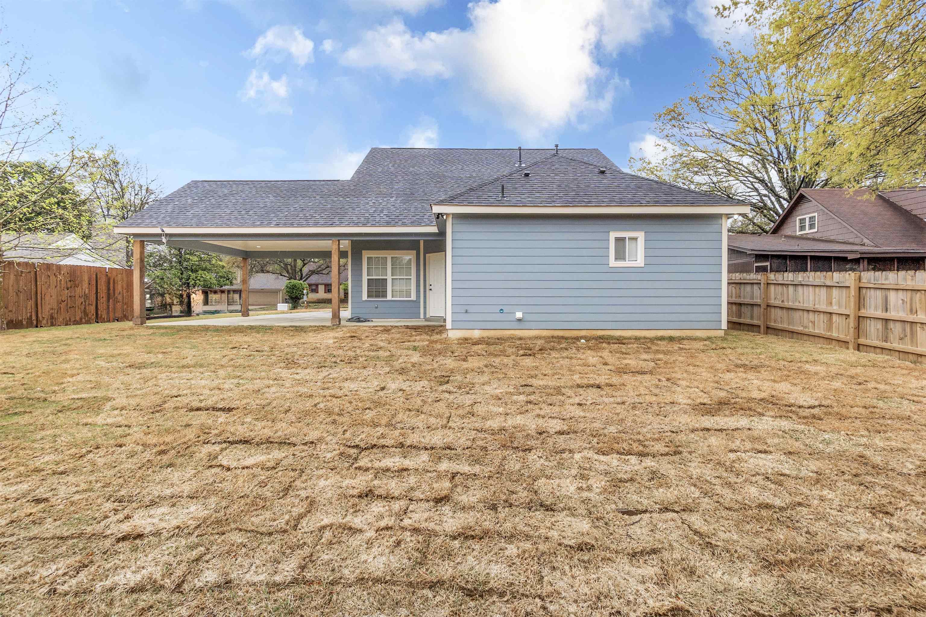 4397 Crescent Park Drive Memphis, TN 38141 - Photo 5 of 40 Back of property featuring a fenced backyard, a lawn, roof with shingles, and a patio