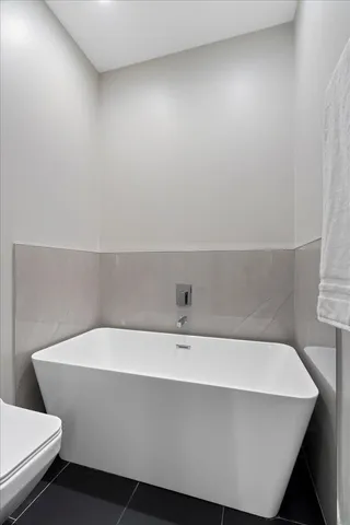 a bathroom with a bathtub and toilet