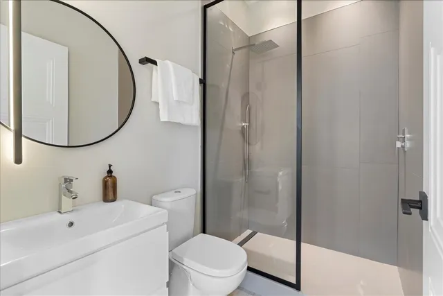 a bathroom with a sink toilet and shower