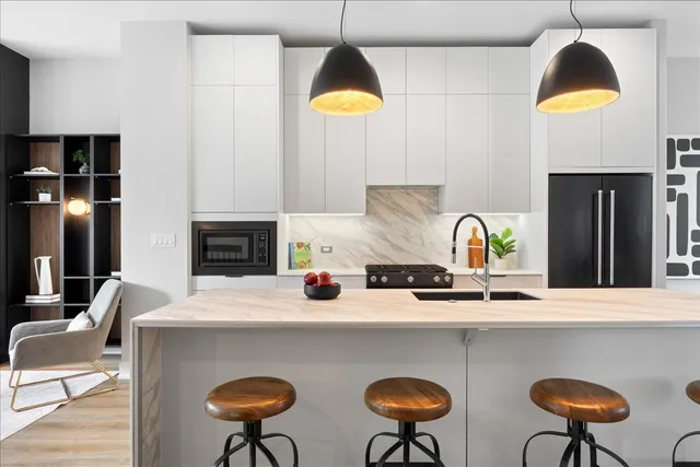 a kitchen with dining table and chairs