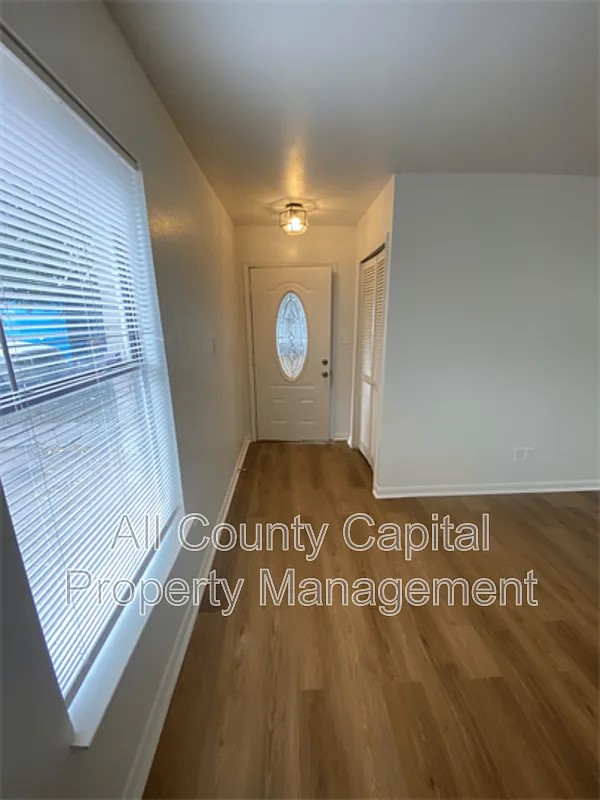 829 Ken Street, Unit B Austin, TX 78753 - Photo 2 of 12 a view of a hallway with wooden floor