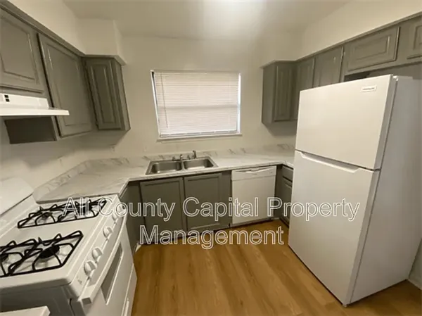a kitchen with a refrigerator and a stove