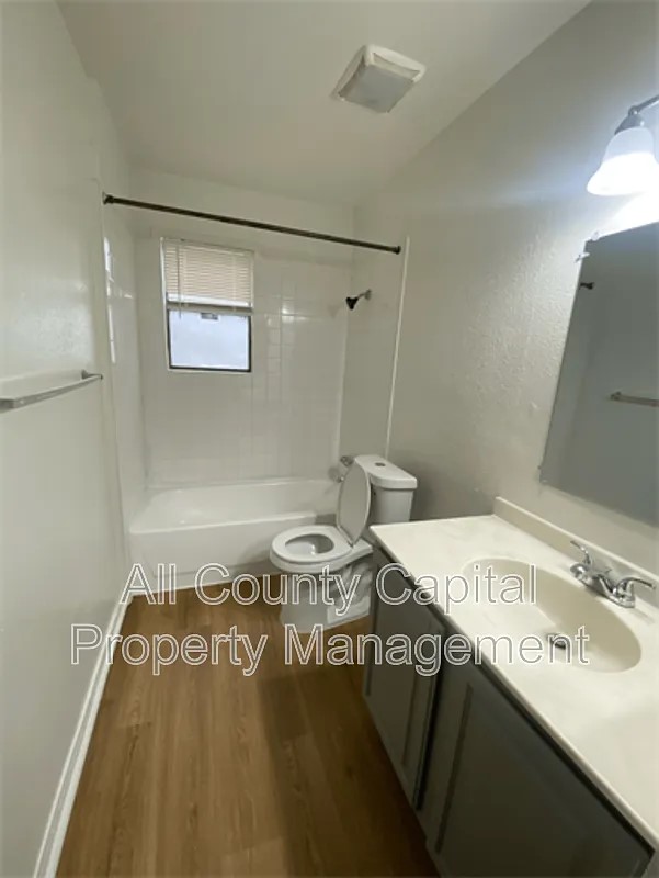 829 Ken Street, Unit B Austin, TX 78753 - Photo 7 of 12 a bathroom with a sink and a mirror