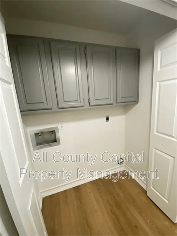 829 Ken Street, Unit B Austin, TX 78753 - Photo 10 of 12 a view of an empty room with wooden floor and cabinets