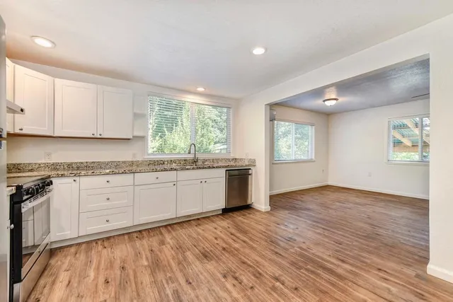 a backyard of a house with lots of green space and a fountain