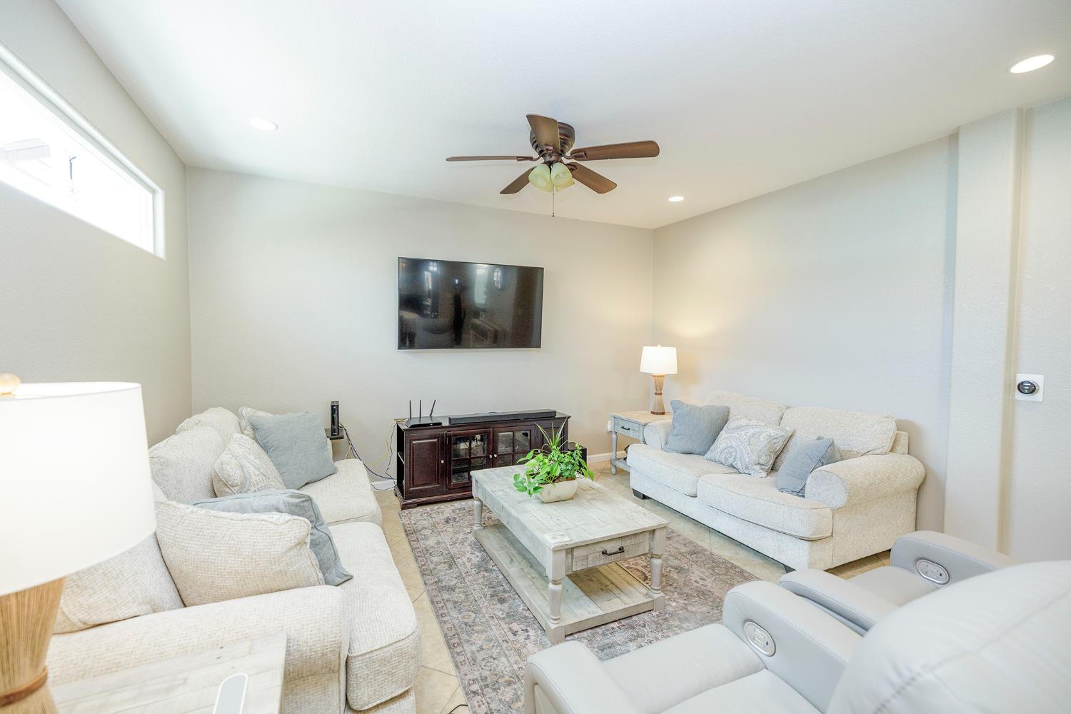 3416 Will Scarlet Way Modesto, CA 95355 - Photo 14 of 56 a living room with furniture and a flat screen tv