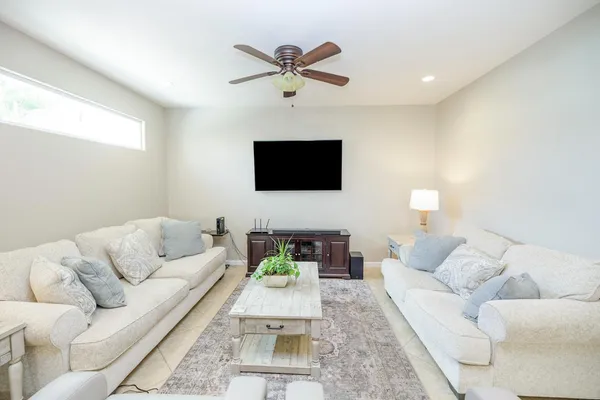a living room with furniture and a chandelier