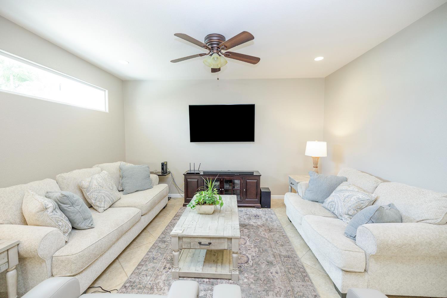 3416 Will Scarlet Way Modesto, CA 95355 - Photo 15 of 56 a living room with furniture and a flat screen tv