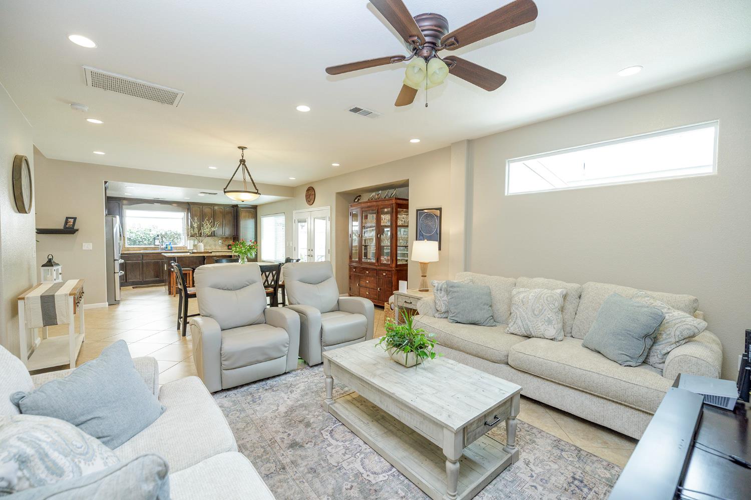3416 Will Scarlet Way Modesto, CA 95355 - Photo 17 of 56 a living room with furniture and a chandelier