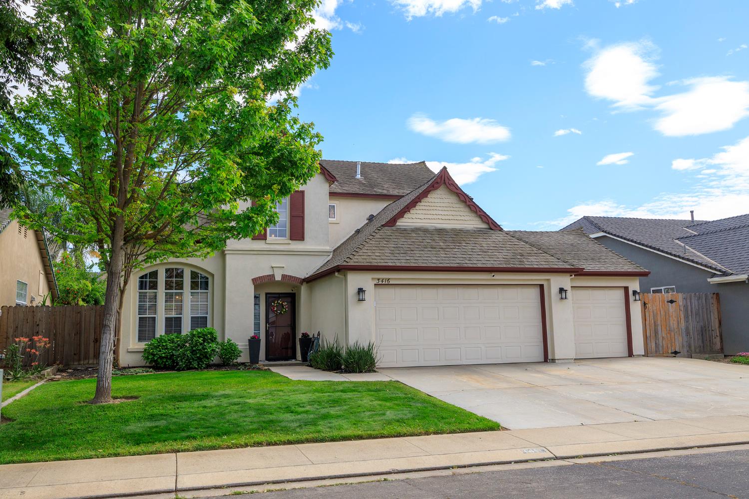 3416 Will Scarlet Way Modesto, CA 95355 - Photo 2 of 56 a front view of a house with a garden