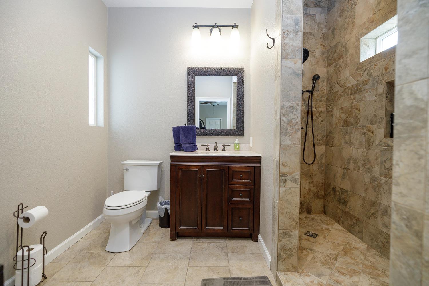 3416 Will Scarlet Way Modesto, CA 95355 - Photo 28 of 56 a bathroom with a sink a toilet and shower