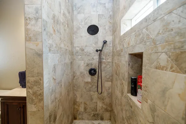 a bathroom with a granite countertop sink mirror vanity and toilet