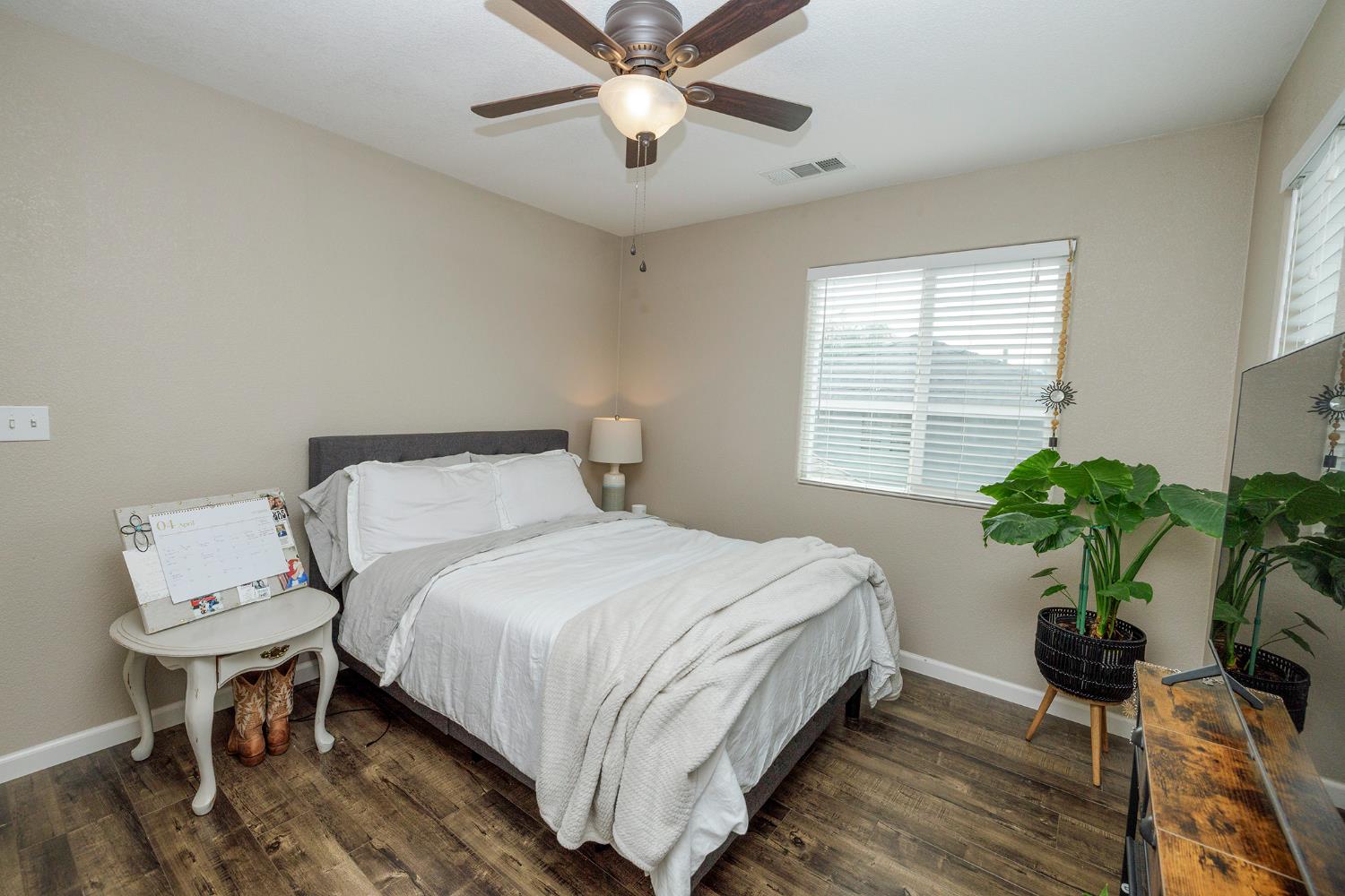 3416 Will Scarlet Way Modesto, CA 95355 - Photo 31 of 56 a bedroom with a bed and a potted plant
