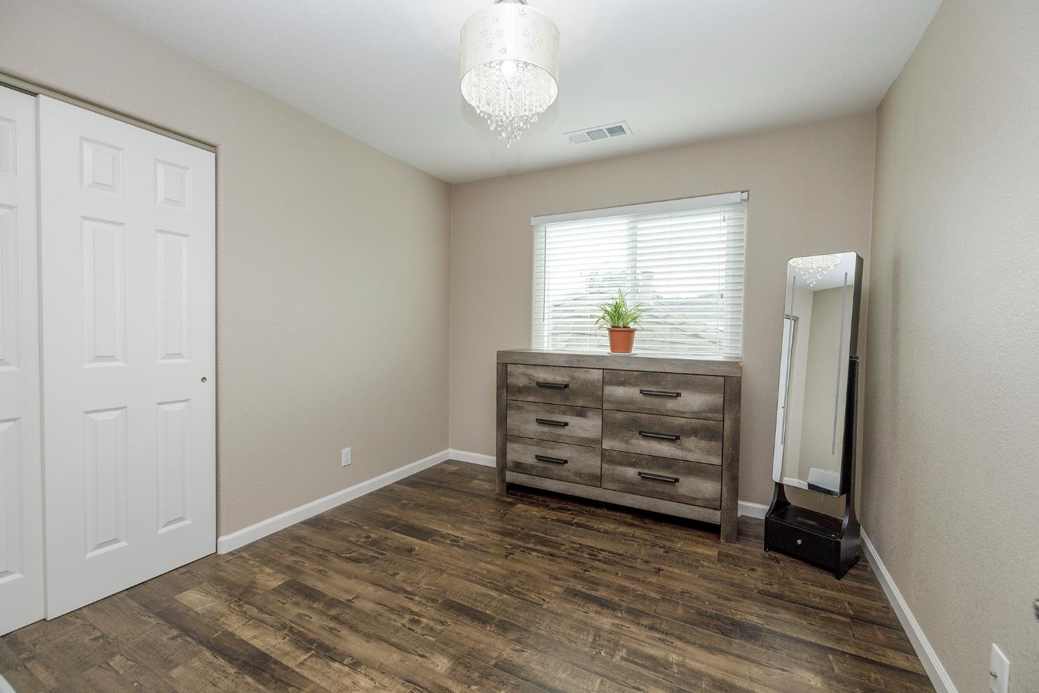 3416 Will Scarlet Way Modesto, CA 95355 - Photo 34 of 56 wooden floor in an empty room with a window