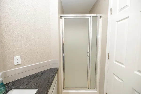 a bathroom with a tub sink and mirror