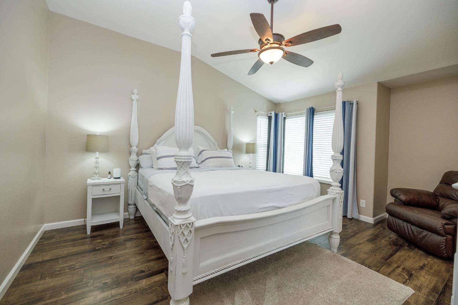 3416 Will Scarlet Way Modesto, CA 95355 - Photo 39 of 56 a bed room with a bed couch and a ceiling fan