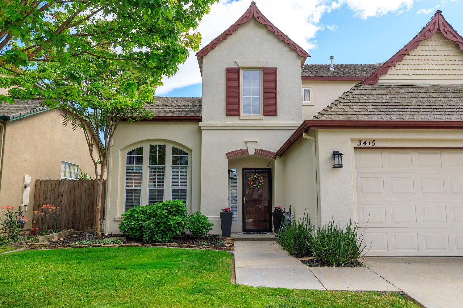 3416 Will Scarlet Way Modesto, CA 95355 - Photo 4 of 56 a front view of a house with a yard and trees