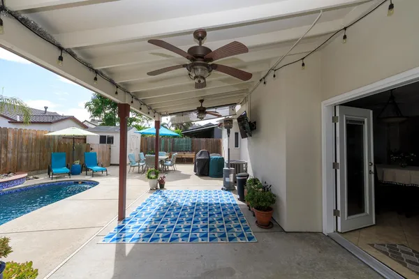 a view of a house with swimming pool and sitting area