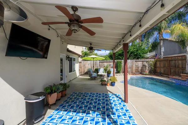 a view of a house with backyard and sitting area