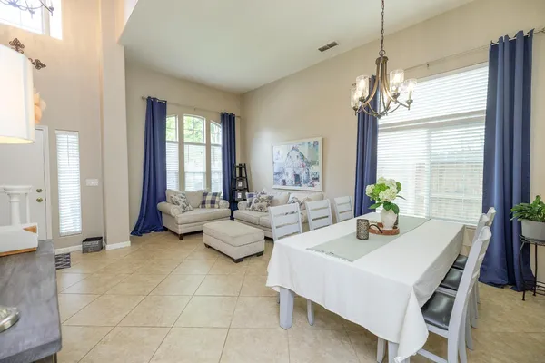 a living room with furniture and a chandelier