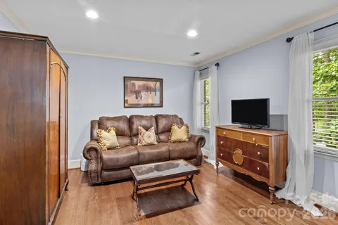 a bathroom with a granite countertop double vanity and a mirror