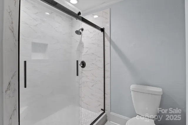 a bathroom with a toilet and shower