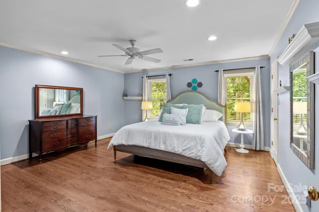 a bedroom with a bed a dresser next to a window