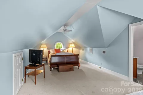 a bathroom with a sink vanity granite tub and a mirror