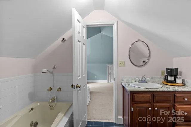 a bathroom with a sink a bathtub and a mirror